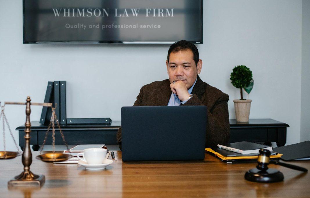 Attorney reviewing documents at a desk, symbolizing financing a law firm.